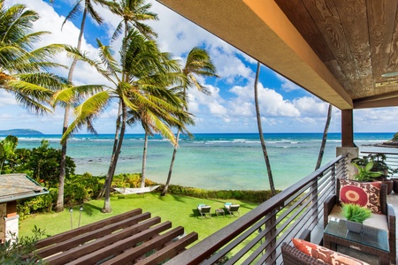 Primary suite lanai reveals postcard-worthy views of swaying palms and turquoise seas.