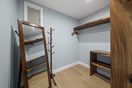 Walk-in closet provides built-in shelves, hanging space, and natural light.