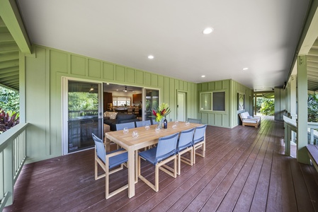 Spacious covered lanai connects the main home and studio, offering shaded group dining with garden views.