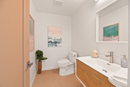 Modern remodeled half bath convenient to entry, dining room and kitchen.