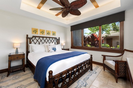 King guest suite with unique island furnishings and lush garden views.