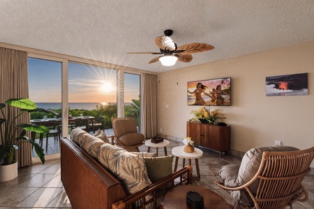 Sunset reaches into the living room through a wall of glass to the water.