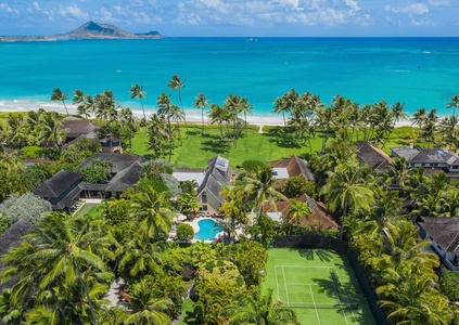 Kailua Shores Estate - USTA approved private Tennis Court nestled within tropical foliage for an exclusive playing experience.