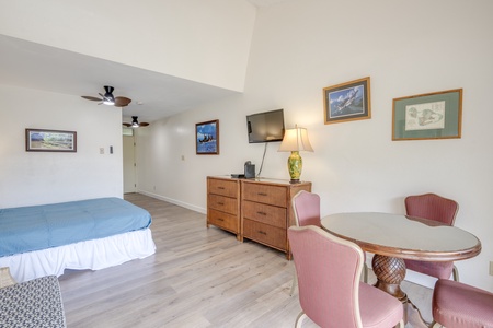 Your spacious suite combines comfort with thoughtful touches—artwork adorns the walls while the dining table offers perfect spots for morning coffee or evening games.