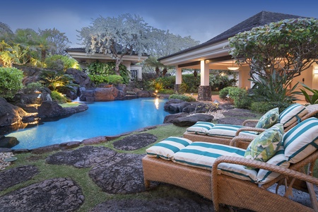 Tropical lagoon style pool and spa with natural rocks and cascading waterfalls.