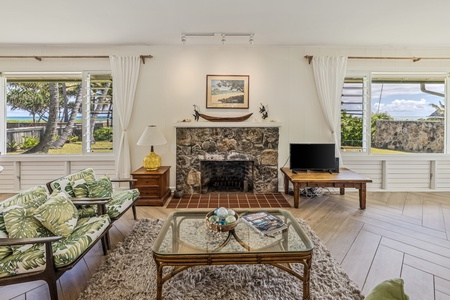 This elegant living space is centered around a beautifully crafted stone fireplace, creating a warm and inviting atmosphere