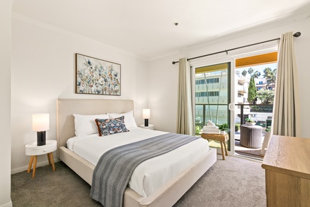 The guest bedroom with direct balcony access—enjoy fresh ocean air and morning sunshine.