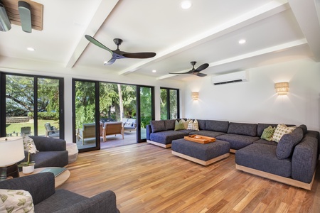 Spacious Living Room with floor to ceiling glass sliders for seamless connection.