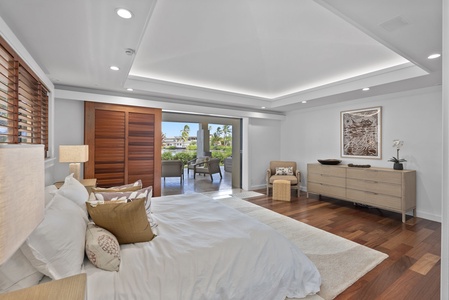 Spacious primary suite with lanai access and serene outdoor views.