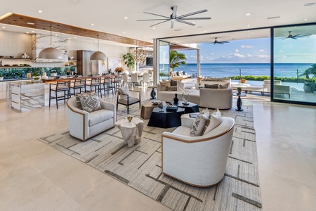 Admire the home’s dramatic design, where walls of glass highlight the pool and beachfront setting.