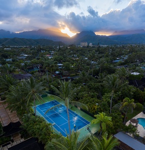 Stunning sunset backdrop over a vibrant pool area creates a magical ambiance.