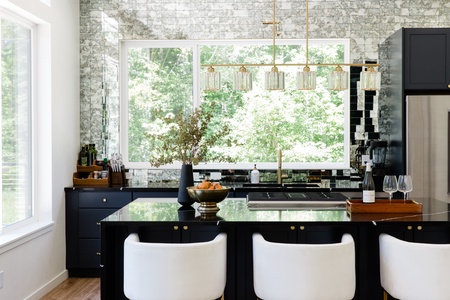 Luxury kitchen and magical backsplash frames your wooded view in this lovely home.