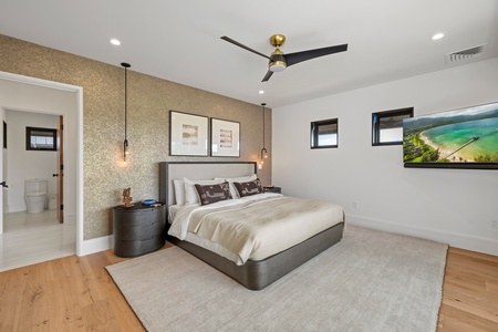 Unwind in this peaceful guest suite featuring cozy textures, king bed, designer lighting, and restful island vibes.