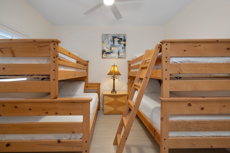 Cozy fourth guest bedroom featuring modern art with twin bunk beds, perfect for kids or guests.
