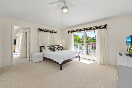 Bright and airy guest suite with large windows, creating a comfortable and inviting space.