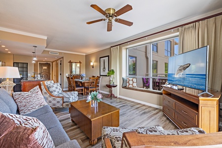 Full-length glass doors create seamless indoor-outdoor flow from the living room to your oversized lanai with scenic views.