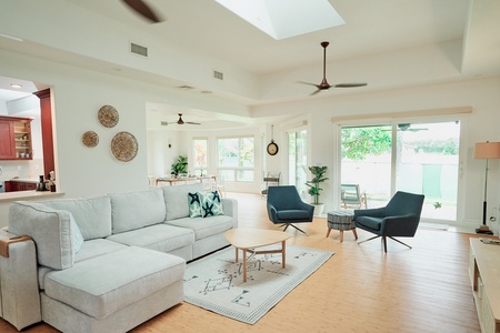 Your bright dining space features large windows and a ceiling fan, perfect for memorable meals with tropical garden views.