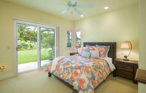 Bright garden-view guest suite with queen bed, private lanai access, and ensuite bath.