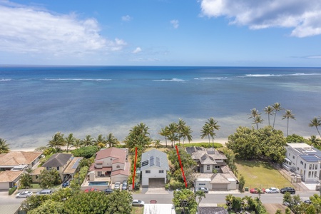 Overhead view of the property nestled along the shoreline, showcasing its prime beachfront location perfect for oceanfront living.
