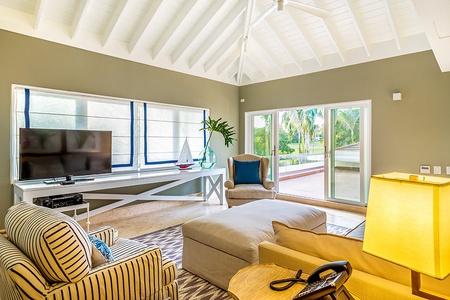 The private study area features a large LCD TV and access to outdoor patio..