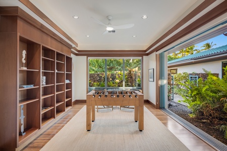 Game room setup with foosball table and open to the living room and access to gated entryway patio.