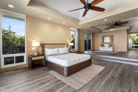 Wake up in your spacious master suite with ocean views, where ceiling fans keep you cool and natural light fills the elegant space.