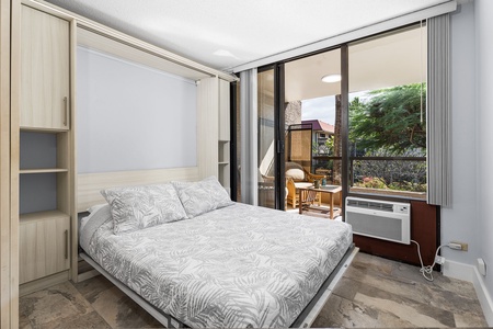 Secondary sleeping area with a comfortable Queen bed and patio access.