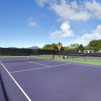 Challenge friends or family at the tennis courts, surrounded by the beautiful scenery of Poipu Beach Athletic Club.