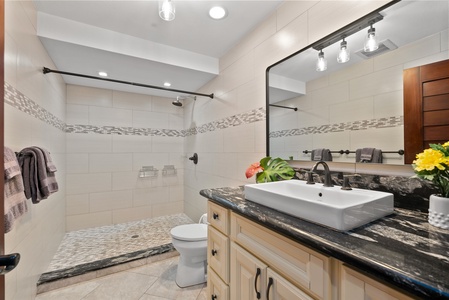 Luxurious bathroom with granite countertops, a spacious vanity, and elegant fixtures.