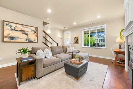 Relax with friends or family in the spacious living room, featuring a large sectional and plenty of natural light.