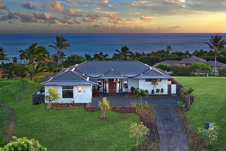 Stunning aerial view of Hiki Moe Hale at Kukui’ula, showcasing lush greenery and an ocean backdrop.