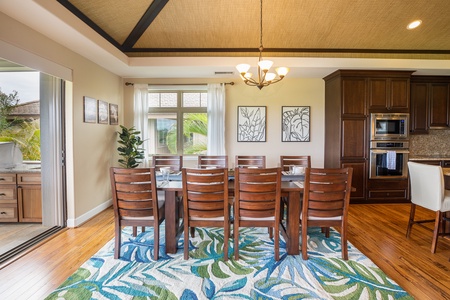 Spacious dining table for eight, open to the lanai for seamless indoor-outdoor flow.