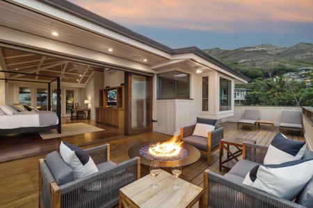 Cozy up around the fire table on the primary suite lanai as twilight sets the perfect ambiance.