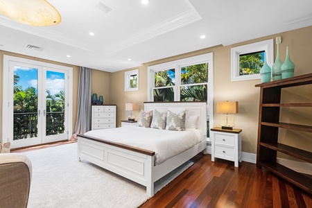 Peaceful studio suite with soft tones and views of tropical greenery.