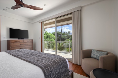 Reverse view of bedroom showcasing wall-mounted Smart TV and lanai access.