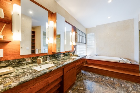 Luxurious primary ensuite with double vanities, soaking tub, and walk-in shower.