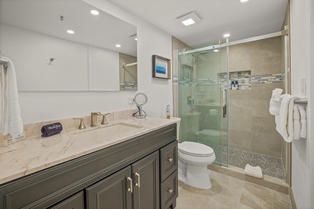Sleek bathroom at Kaanapali Shores 213 with a glass walk-in shower and modern vanity.