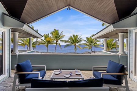 Upper lanai from the primary suite showcases panoramic views and elevated comfort.