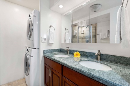 The shared guest bathroom with dual vanities and a walk-in shower.
