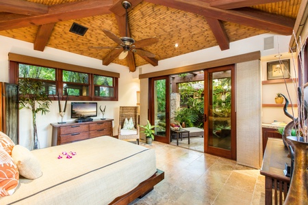 Downstairs west guest suite with lanai access and peaceful garden surroundings.
