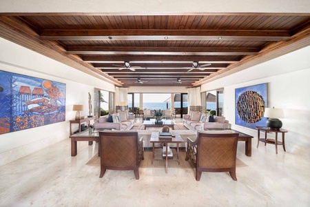 Spacious living area with ocean views and elegant vaulted ceilings.