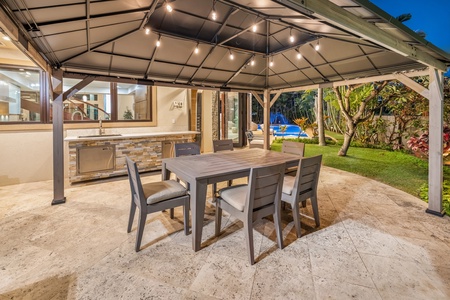 The outdoor kitchen area is perfect for evening grilling and al fresco dining under the stars.