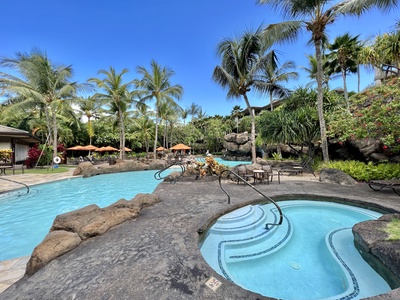 Relax by the tropical pool and hot tub, surrounded by lush palms and serene landscaping. Perfect for unwinding in paradise.