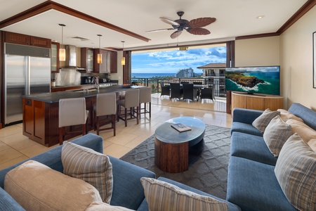 The living area with TV and sectional, looking to the lanai and beyond.