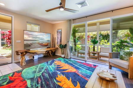 The bright and open living room features plenty of natural light and tropical decor.