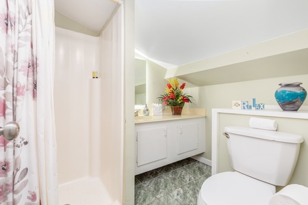Loft ensuite bath with a wide vanity space & walk-in shower.