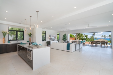 The kitchen overlooks the living area, allowing for easy conversation while preparing meals in your Hawaii vacation retreat.