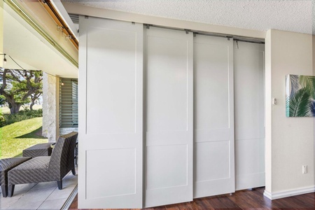 Sleek sliding doors separating the second guest bedroom with outdoor seating area.