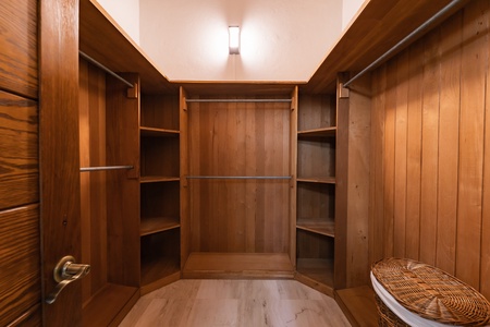 Walk-in closet with ample storage space, crafted with beautiful wooden details.