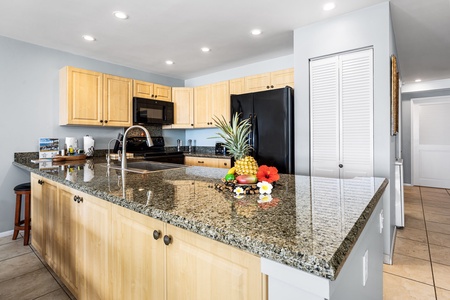 Spacious granite countertops and ample cabinetry make this kitchen ideal for prepping fresh island meals.